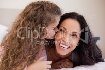 Daughter giving her mother a kiss on the cheek