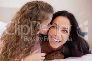 Daughter giving her mother a kiss on the cheek