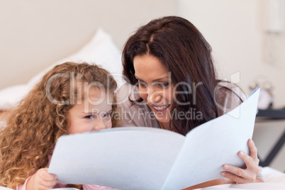 Mother and daughter reading a book together