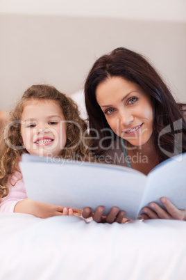 Mother and daughter reading bedtime stories together