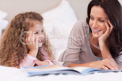 Mother reading a bedtime story for her daughter