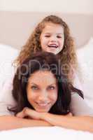 Girl sitting on her mothers back