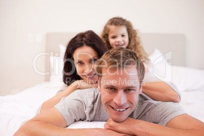 Joyful family having a good time in the bedroom