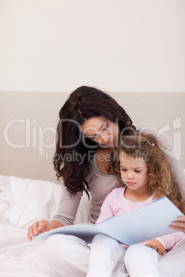 Mother reading a story for her little daughter