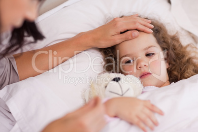 Mother taking care of her ill daughter