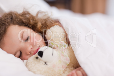 Girl sleeping with her teddy