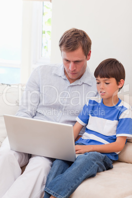 Father and son surfing the internet together