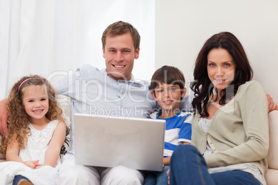 Family surfing the internet in the living room together