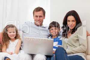 Family surfing the internet in the living room together