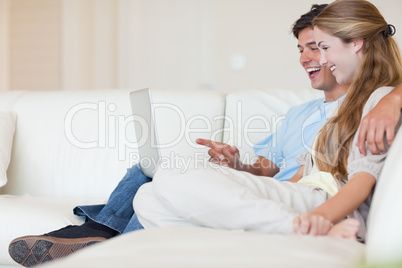 Happy couple using a laptop