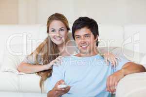 Happy couple watching television