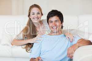 Smiling couple watching television