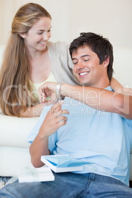 Portrait of a woman offering a watch to her fiance