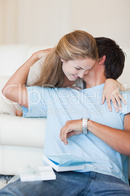Portrait of a woman offering a watch to her boyfriend