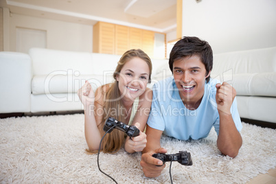 Cheerful young couple playing video games