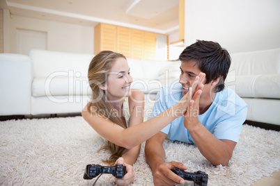 Playful young couple playing video games