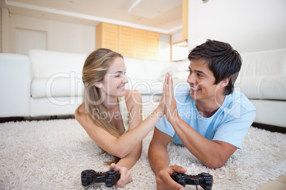 Playful cute couple playing video games