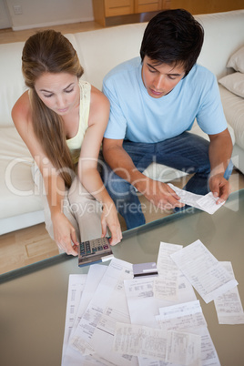 Portrait of a young couple looking at their bills