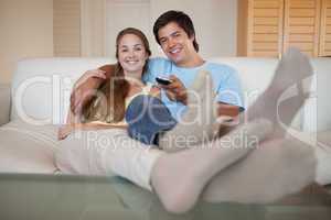Relaxed young couple watching television