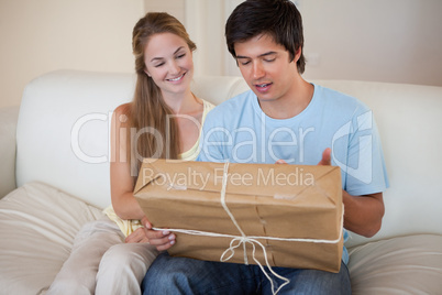 Young couple looking at a package