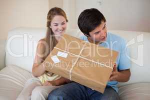 Smiling couple opening a package