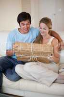 Portrait of a young couple looking at a package