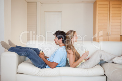 Couple sitting back to back with a glass of wine