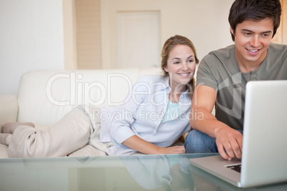 Relaxed couple using a notebook