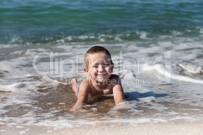 Child boy on sea beach