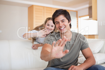 Couple waving at the camera