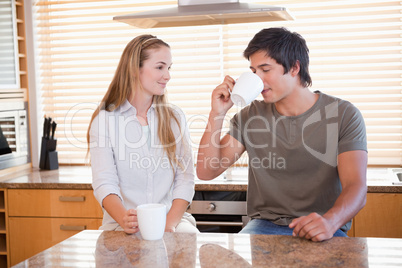 Smiling couple having a cup of coffee