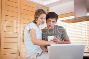 Couple having coffee while using a notebook
