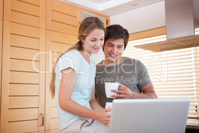 Couple having tea while using a notebook