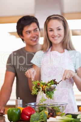 Portrait of a couple making a salad