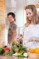 Portrait of a lovely couple making a salad