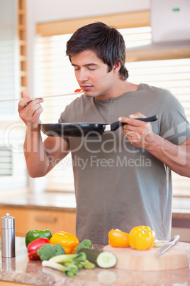 Portrait of a young man tasting his meal