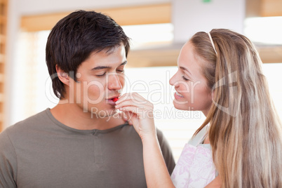 Man tasting the meal of her fiance