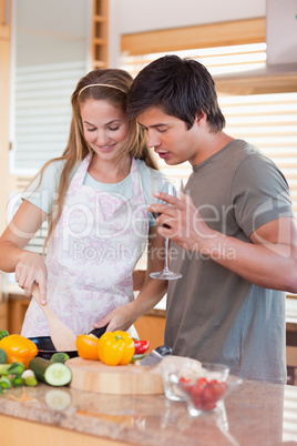 Portrait of a couple cooking while drinking wine