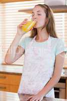 Portrait of a woman drinking orange juice