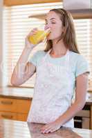 Portrait of a beautiful woman drinking orange juice