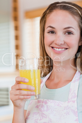 Portrait of a gorgeous woman drinking orange juice