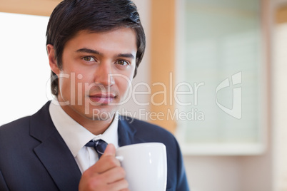 Close up of a handsome businessman drinking coffee