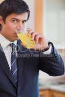 Portrait of a businessman drinking orange juice