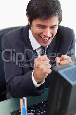 Portrait of a cheerful businessman working with a computer