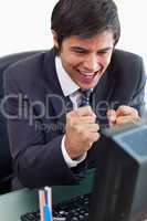 Portrait of a cheerful businessman working with a computer