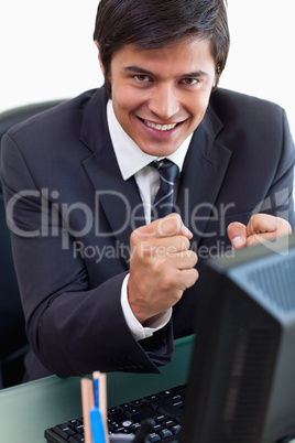 Portrait of a satisfied businessman working with a computer