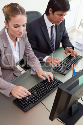 Portrait of young business people working with computers