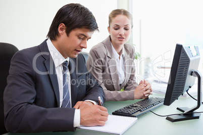 Serious business people working with a computer