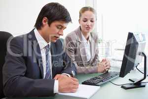 Serious business people working with a computer