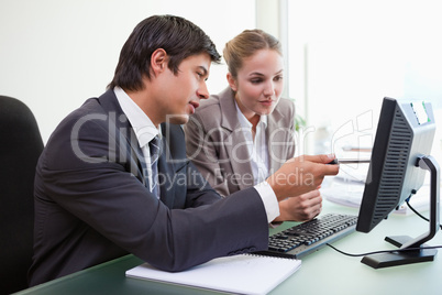 Focused business team working with a computer